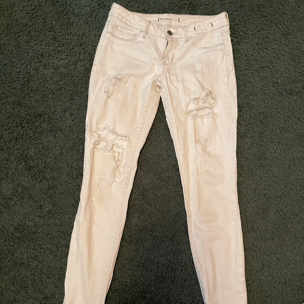 Distressed white jeans